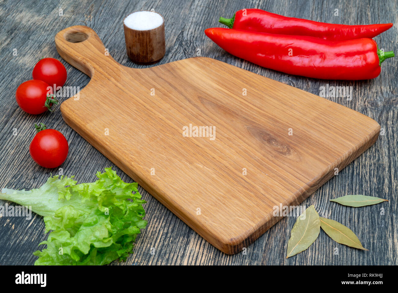 Oak cutting board on the kitchen table. Stock Photo