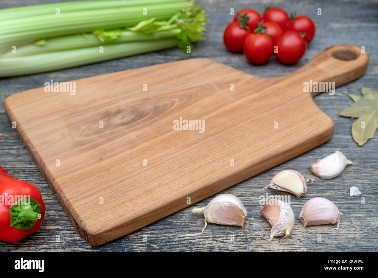 Oak cutting board on the kitchen table. Stock Photo