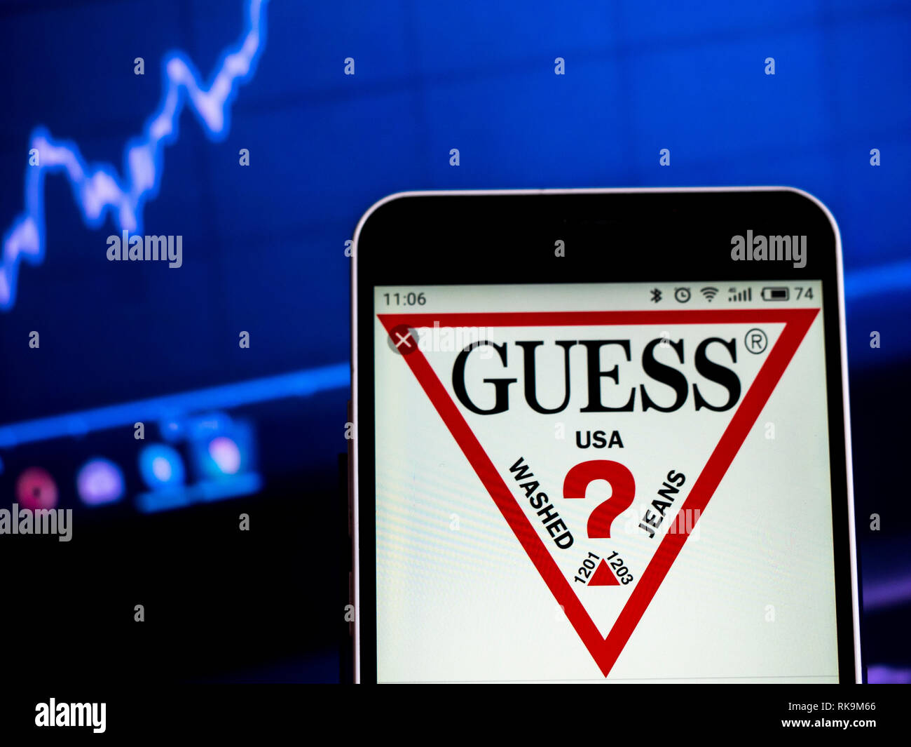 Guess Clothing company logo seen displayed on smart phone Stock Photo