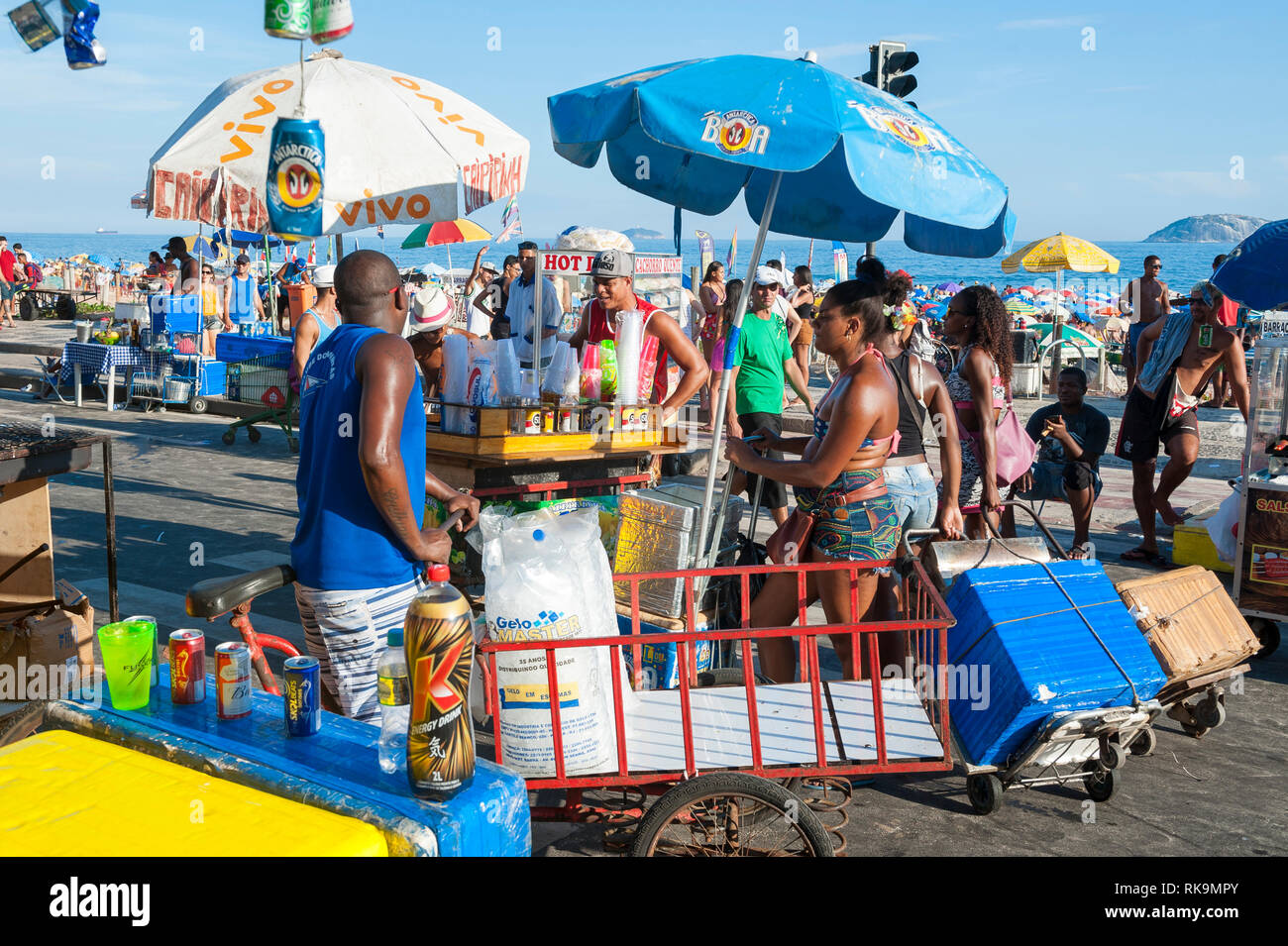 RIO DE JANEIRO - FEBRUARY 28, 2017: Unlicensed Brazilian vendors selling drinks and snacks line the street at a Carnival street party in Ipanema. Stock Photo