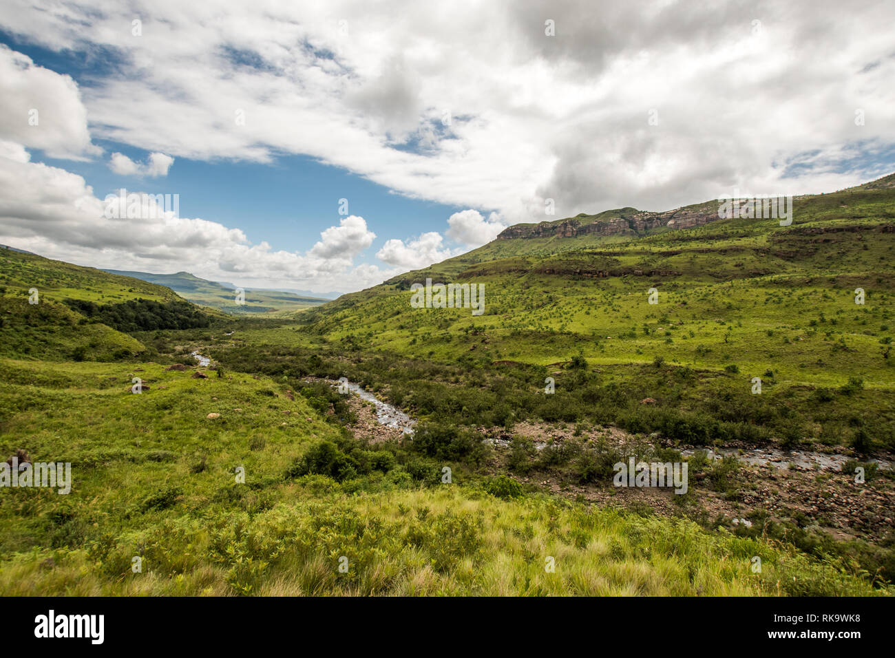 Hills and the Tugela River along the Tugela Gorge hiking route at the base of the Amphitheatre mountain. Drakensberg, South Africa Stock Photo