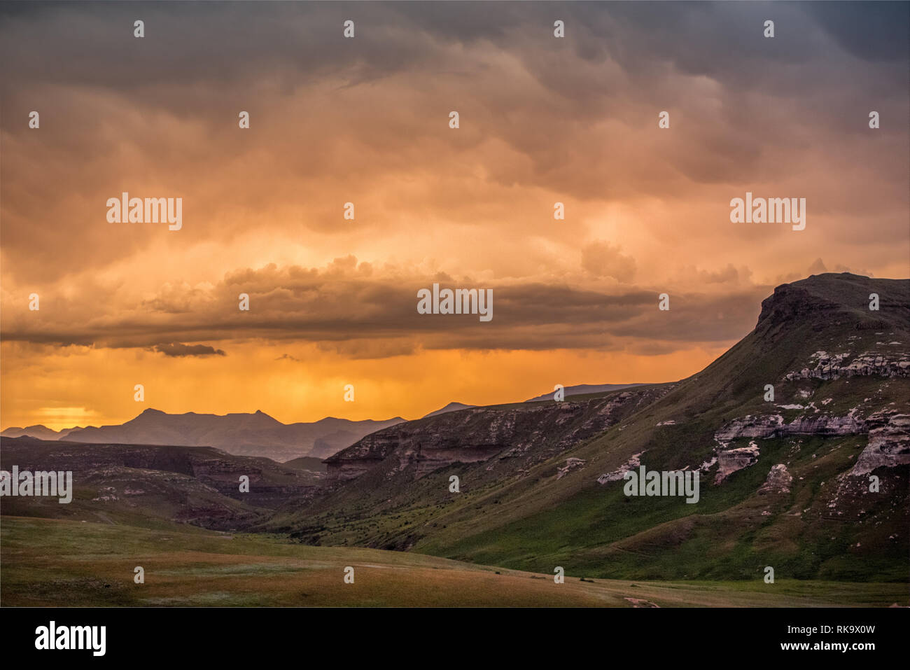 Cliffs and mountains under dramatic colorful storm clouds at sunset ...