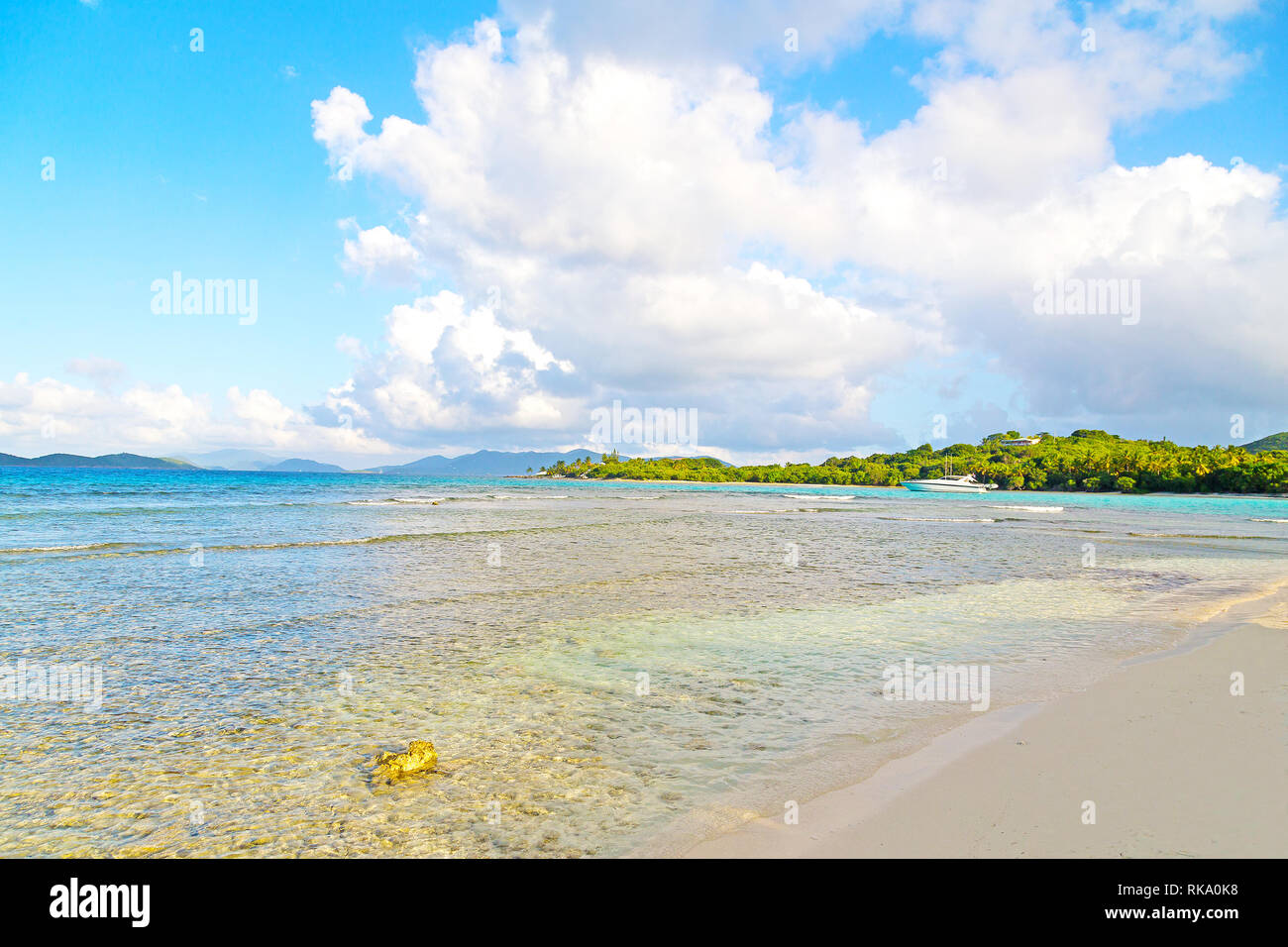 Low tide at sunset on Lindquist Beach, US Virgin Islands. Beautiful beach on St Thomas Island and other islands on horizon. Stock Photo