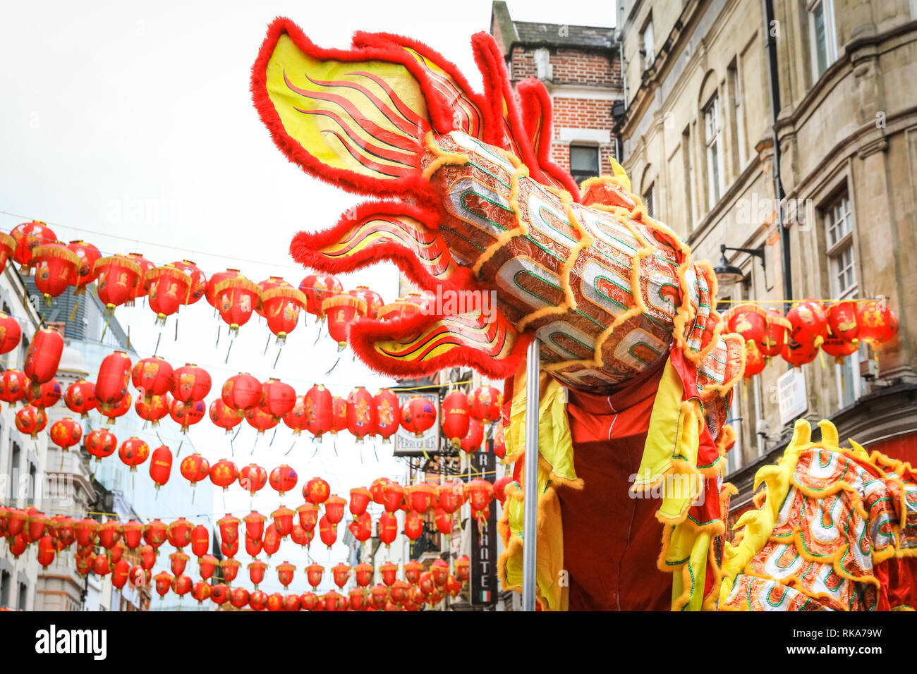 London, UK 10th Feb 2019. The dragon at the front of the procession. The performers make their way through Soho. London's Chinese New Year celebrations, the largest outside Asia, take place with colourful parades, lion and dragon dances, a procession through Soho, cultural performances and displays in and around Chinatown, the West End and Trafalgar Square. 2019 welcomes the Year of the Pig. Credit: Imageplotter News and Sports/Alamy Live News Stock Photo