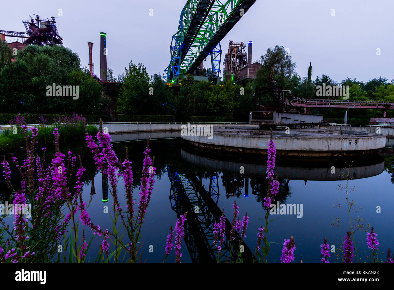 Duisburg - View to Water Reservoir at Landschaftspark Duisburg-Meiderich with huge Crane reflected in the Water, North Rhine Westphalia Stock Photo