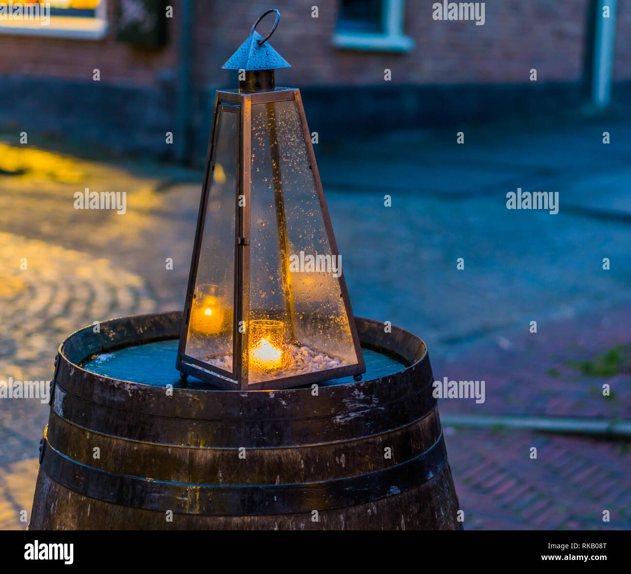 lighted candle in a glass pyramid, city light decorations Stock Photo