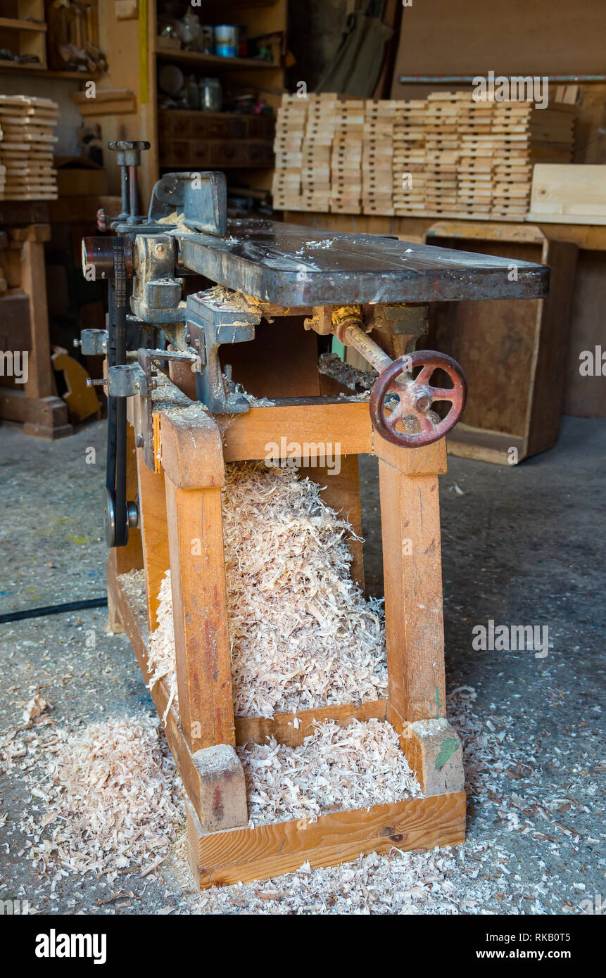 Old and used planing machine in the joinery workshop. Stock Photo