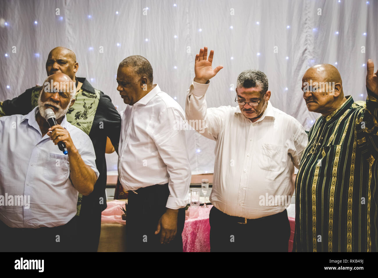 Group of men worshiping and praying Stock Photo Alamy