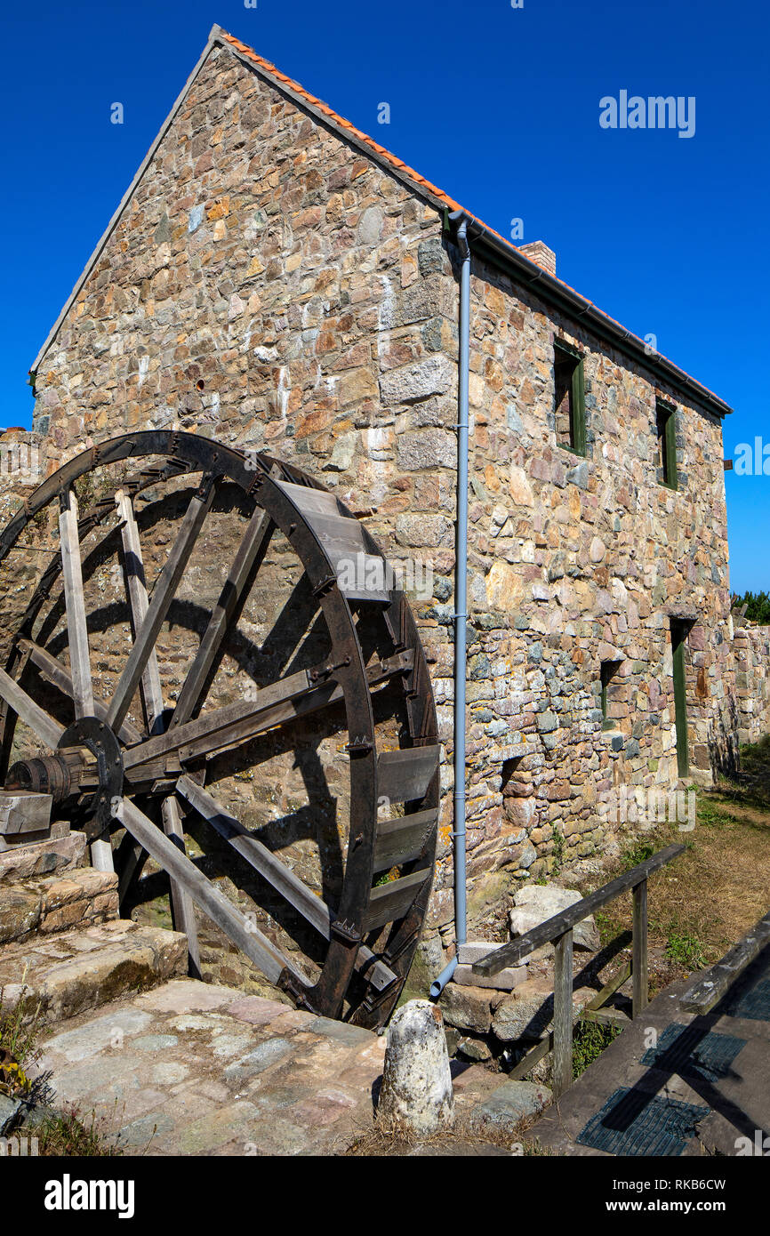 The old watermill and water wheel recently rebuilt near watermill farm on Alderney. Stock Photo