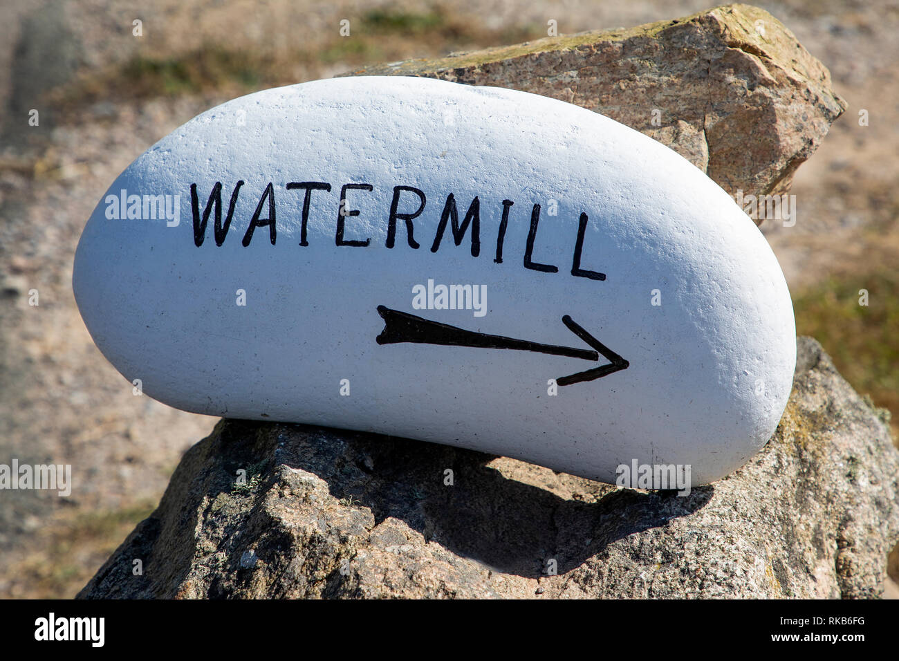 Signpost to the recently rebuilt watermill near to Fort Tourgis on Alderney. Stock Photo