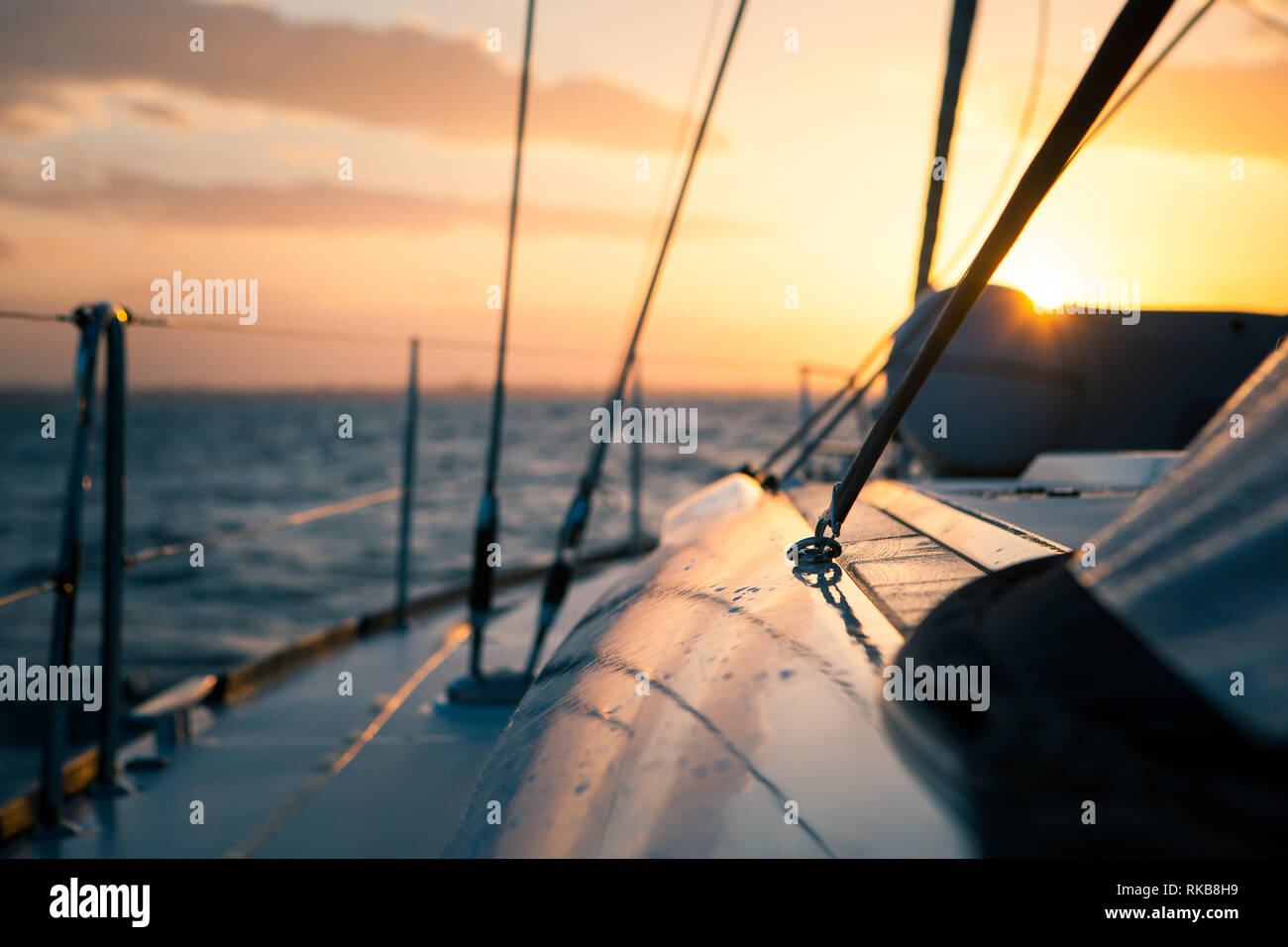 Sailing yacht at sunset in the open sea Stock Photo - Alamy