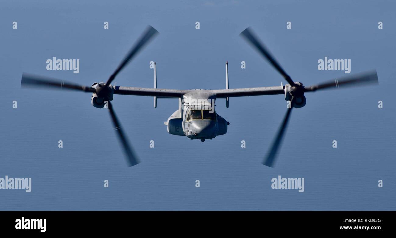 An MV-22 Osprey with the 22nd Marine Expeditionary Unit transports personnel, mail and cargo over the Arabian Sea in route to the Wasp-class amphibious assault ship USS Kearsarge (LHD-3). The Osprey, attached to the Marine Medium Tiltrotor Squadron 264 (Reinforced), flew to the Kearsarge from Qatar.  Marines and Sailors with the 22nd MEU and Kearsarge Amphibious Ready Group are deployed to the 5th Fleet area of operations in support of naval operations to ensure maritime stability and security in the Central Region, connecting the Mediterranean and the Pacific through the western Indian Ocean  Stock Photo