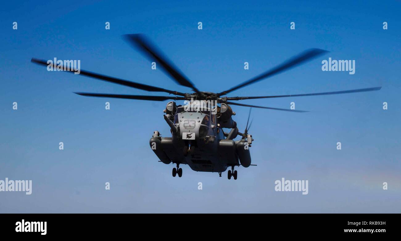 190205-M-QP631-1007 ARABIAN SEA (Feb. 1, 2019) A CH-53E Super Stallion with the 22nd Marine Expeditionary Unit flies across the Arabian Sea in route to the Wasp-class amphibious assault ship USS Kearsarge (LHD-3). The Super Stallion, attached to Marine Medium Tiltrotor Squadron 264 (Reinforced), was peforming routine flight operations. Marines and Sailors with the 22nd MEU and Kearsarge Amphibious Ready Group are deployed to the 5th Fleet area of operations in support of naval operations to ensure maritime stability and security in the Central Region, connecting the Mediterranean and the Pacif Stock Photo