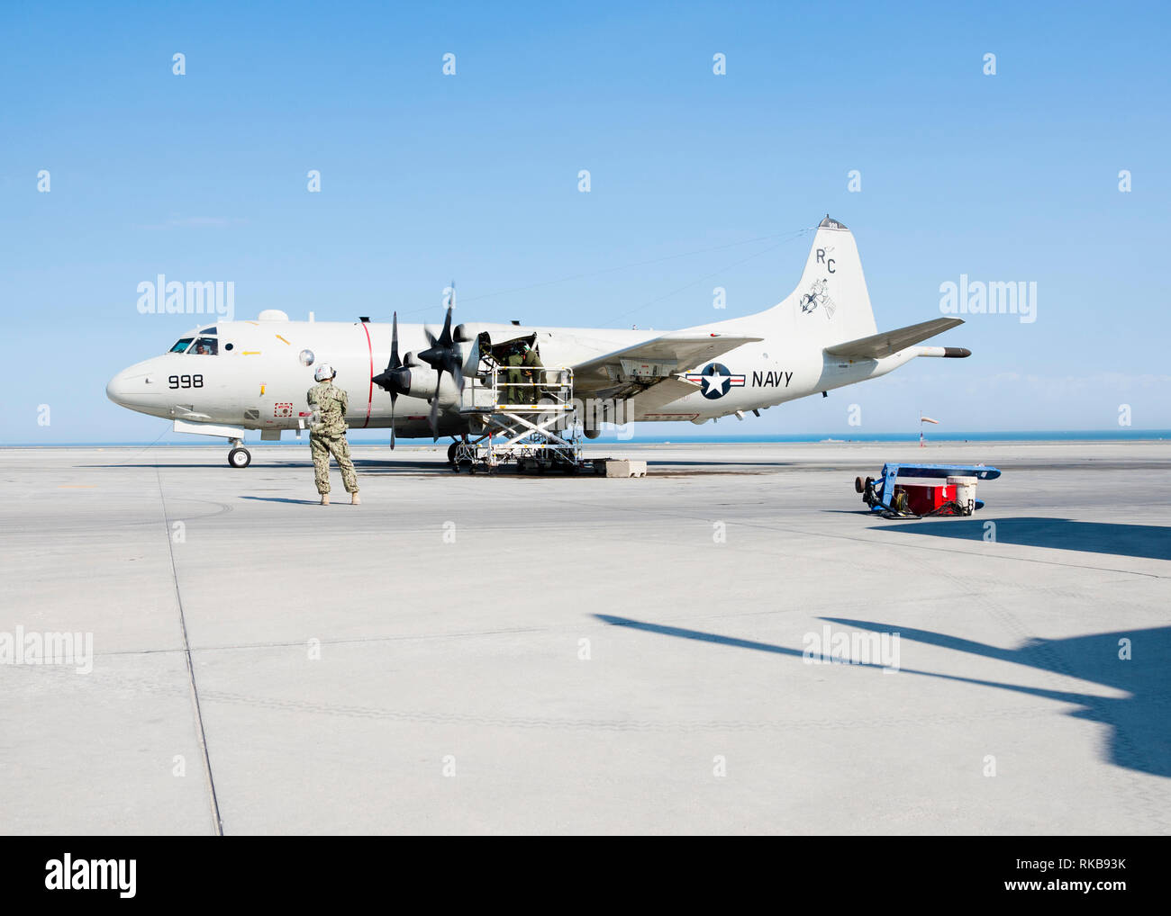 190206-N-KT659-1017 U.S. 5TH FLEET AREA OF OPERATIONS (Feb. 6, 2019) Master Chief Anthony Garcia, assigned to the “Grey Knights” of Patrol Squadron (VP) 46, observes as Sailors check the engine of a P-3C Orion anti-submarine warfare patrol aircraft during a maintenance check. VP-46 is currently deployed to the U.S. 5th Fleet and U.S. 7th Fleet areas of operations in support of Operation Inherent Resolve. While in this region, VP-46 is supporting naval operations to ensure maritime stability and security in the Central Region, connecting the Mediterranean and the Pacific through the western Ind Stock Photo