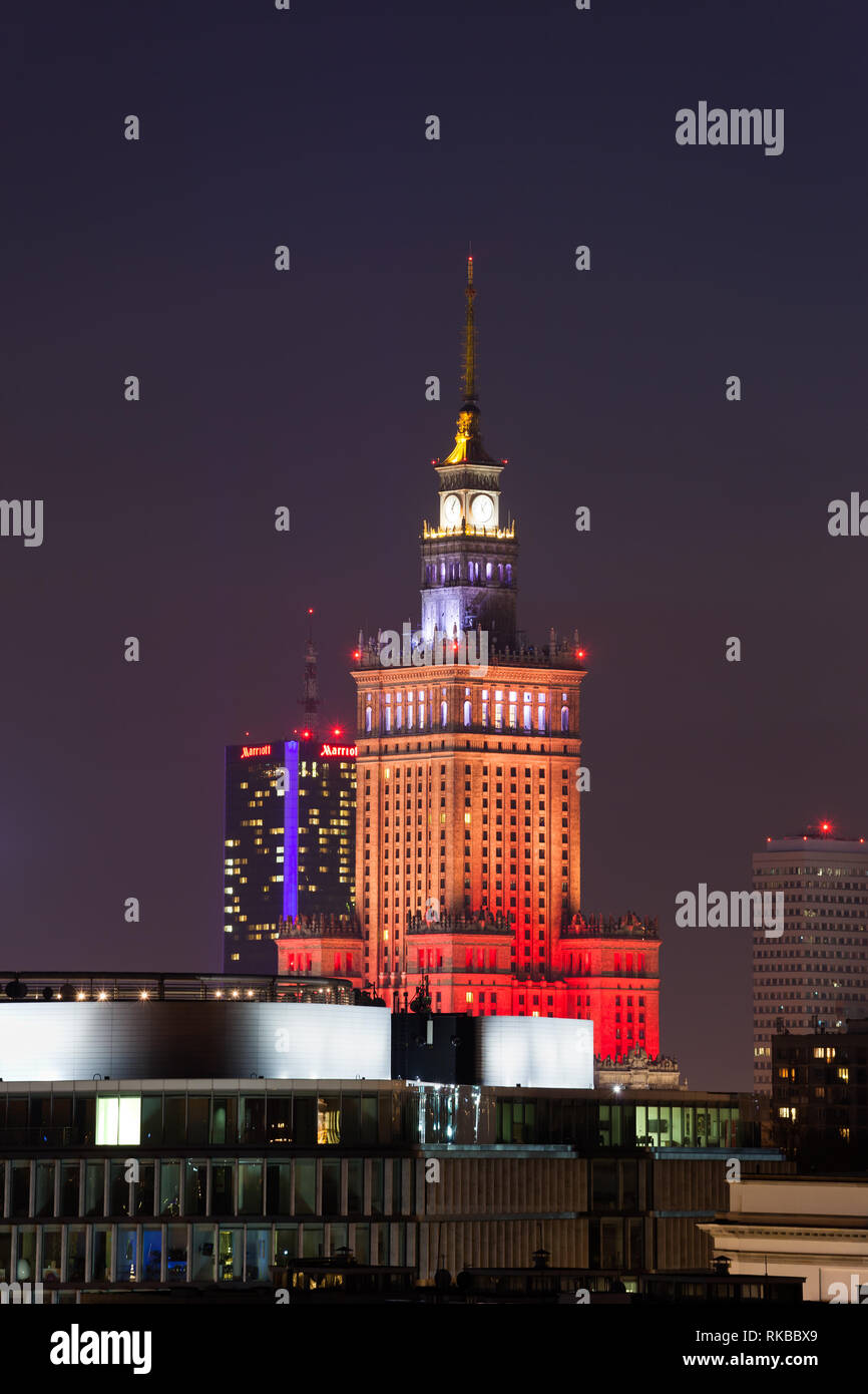 Palace of Culture and Science illuminated at night in city of Warsaw in Poland Stock Photo