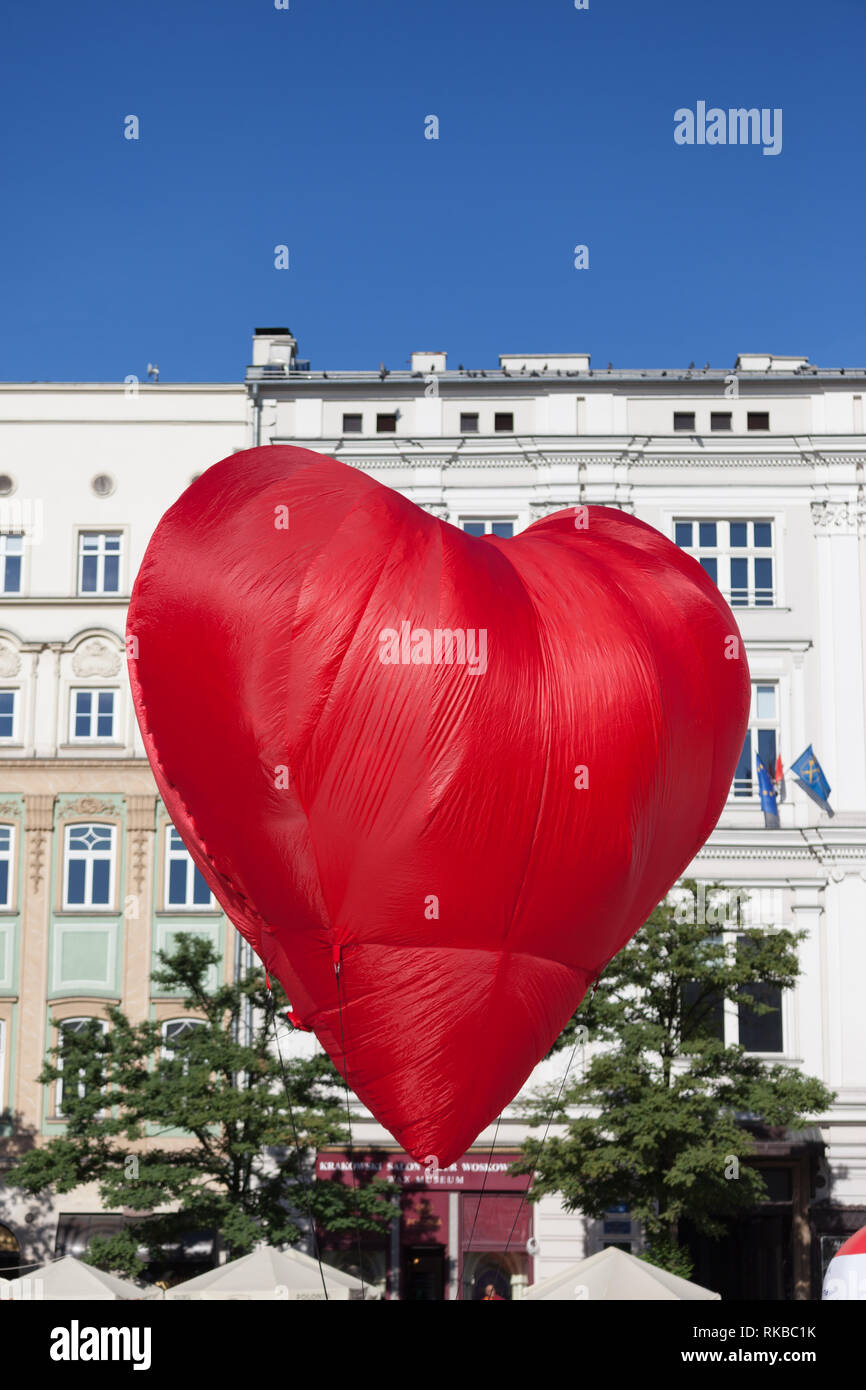 Heart shaped big red balloon in the city Stock Photo