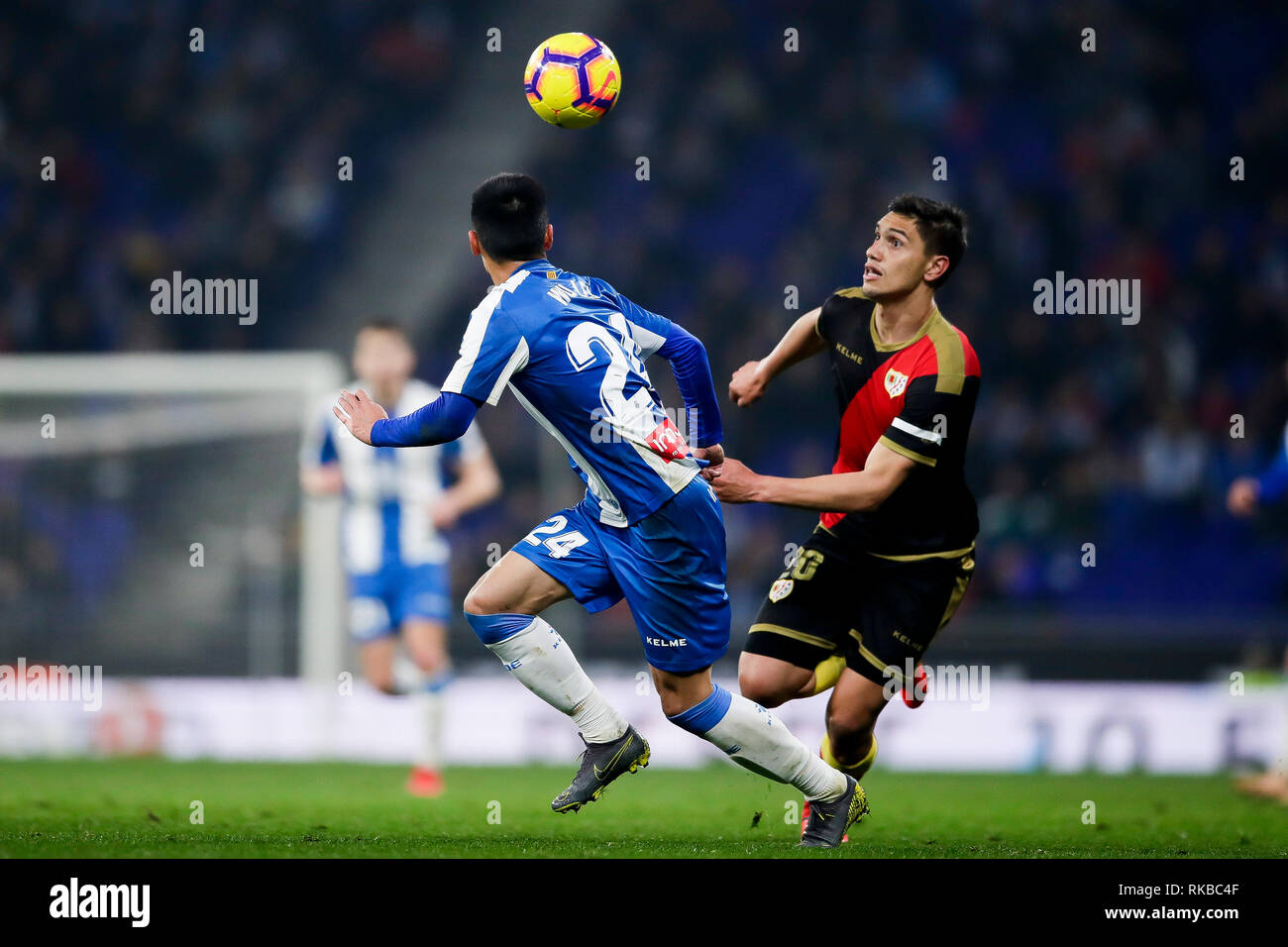 Wu Lei of RCD Espanyol challenges for the ball against Emiliano Velázquez of Rayo Vallecano during La Liga match between RCD Espanyol and Rayo Vallecano at RCDE Stadium in Barcelona. Final Score:  rcd espanyol 2 - 1 rayo vallecano. Stock Photo