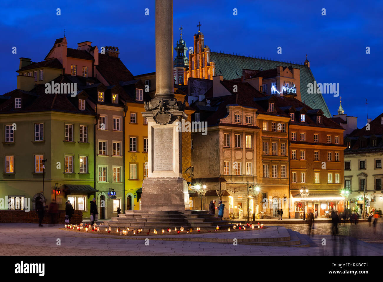 City of Warsaw by night, capital of Poland, Old Town colorful tenement houses and base of the Zygmunt's Column. Stock Photo