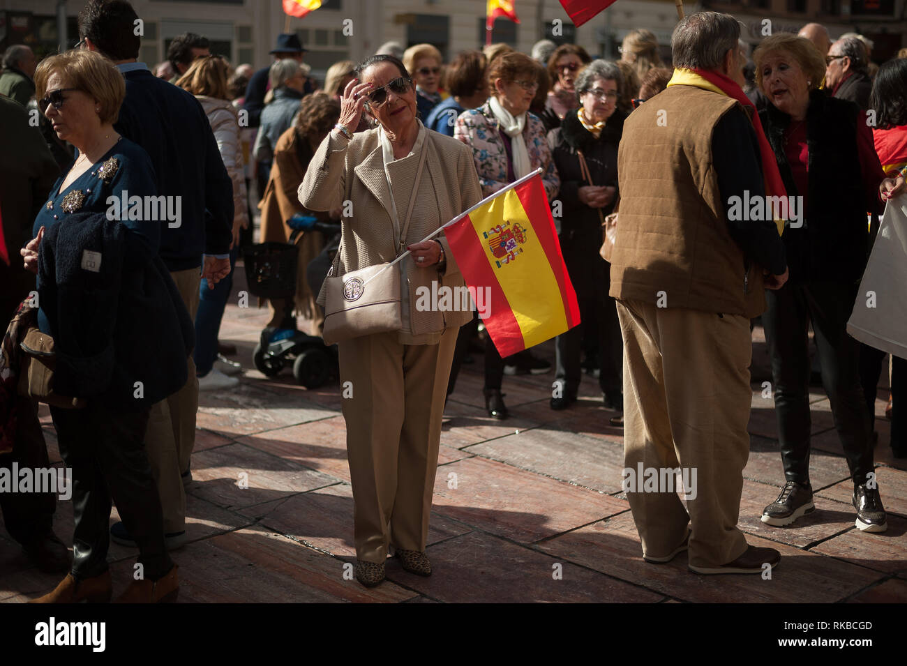 A supporter of the unite between Spain and Catalonia called by right parties, seen holding a Spanish flag as she takes part in a demonstration against the Spanish government of Pedro Sánchez. Stock Photo