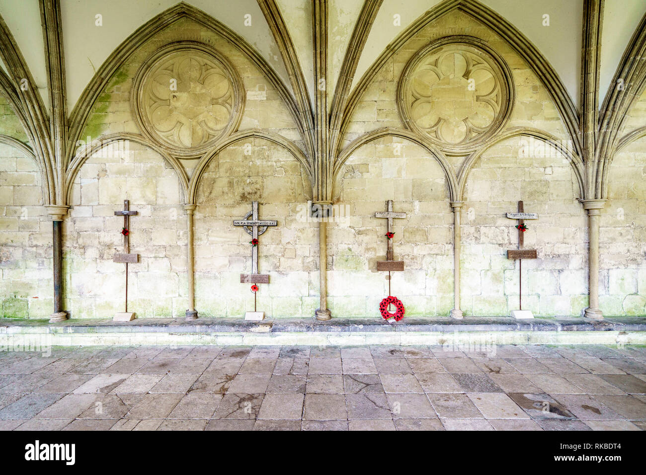 Row of old wooden war grave markers mounted on display in Salisbury Cathedral cloisters Stock Photo