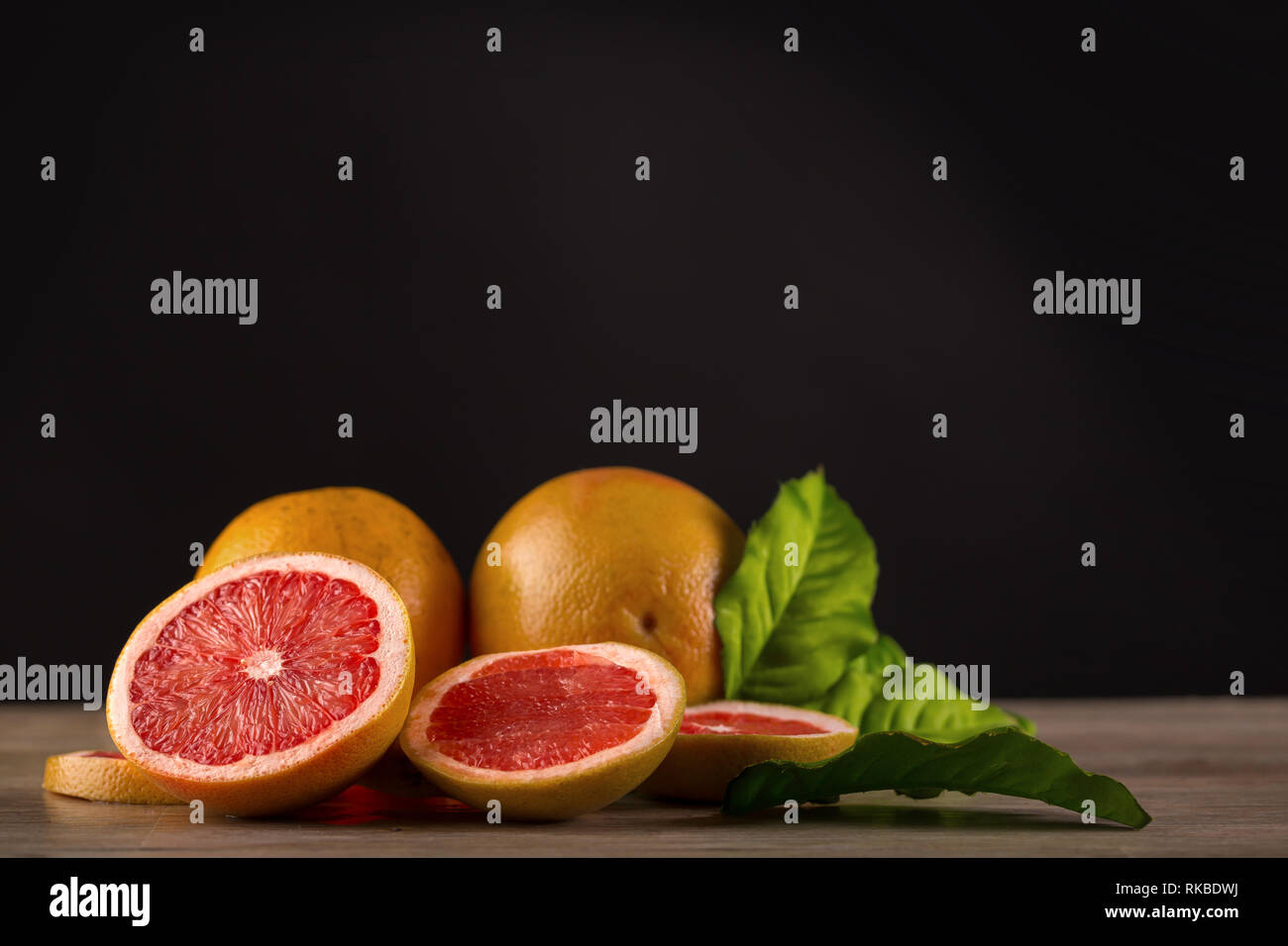 grapefruit on wooden table with black background Stock Photo
