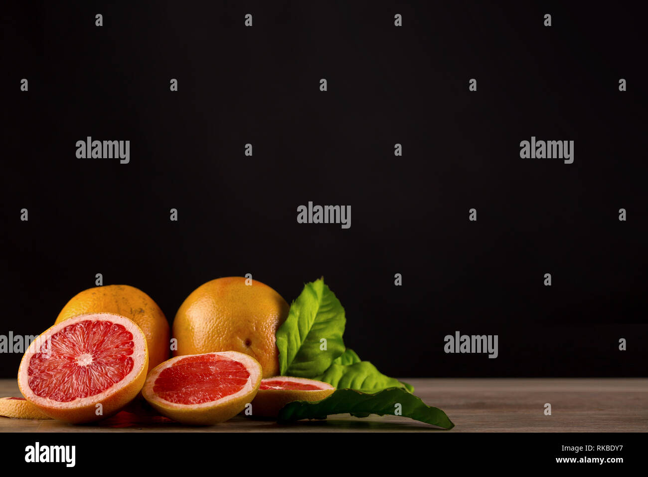 grapefruit on wooden table with black background Stock Photo