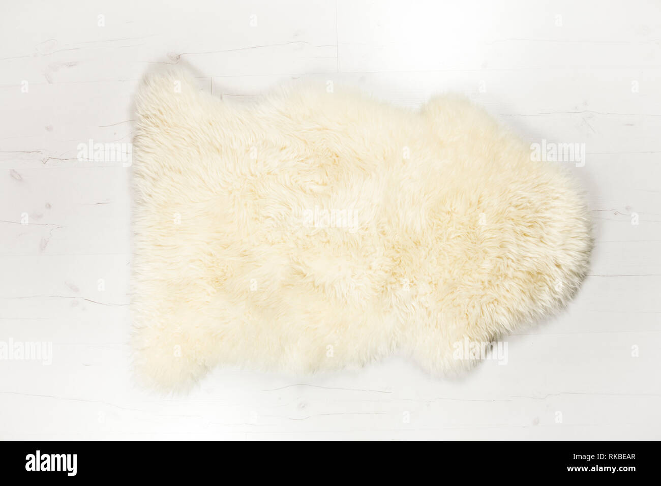 Flat lay view of white warm and cozy whole real decorative sheepskin