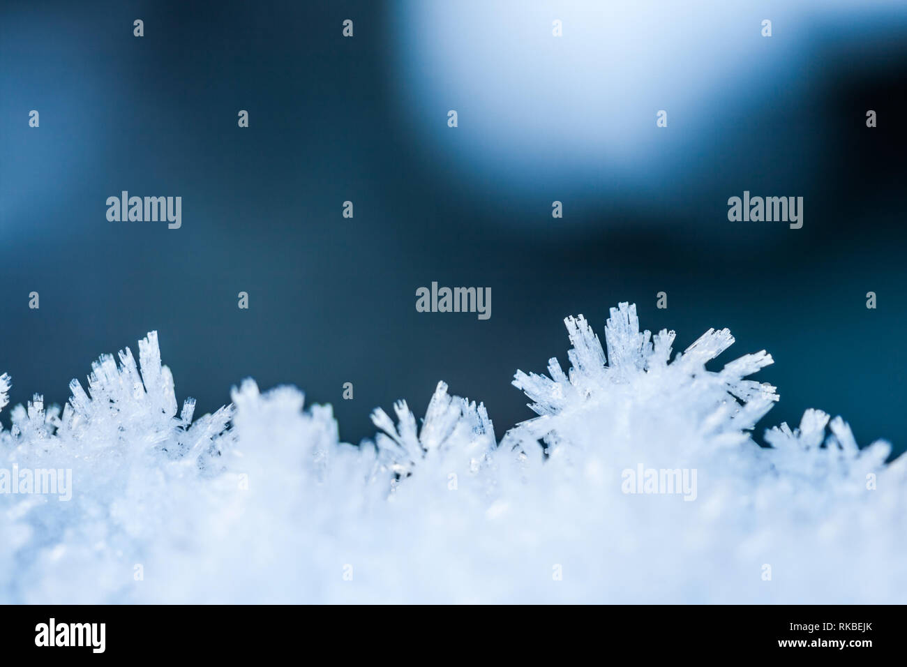 Snowflakes falling on blue background hi-res stock photography and ...