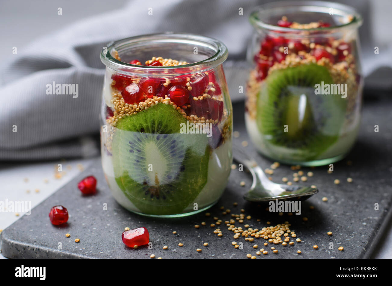 Yogurt Parfait with Puffed Quinoa, Kiwi and Pomegranate Seeds, Healthy Dessert Stock Photo