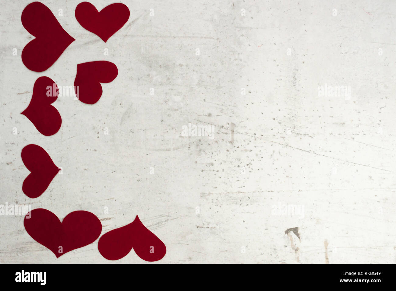 Red paper hearts on white concrete background. Selective focus. Copy space Stock Photo