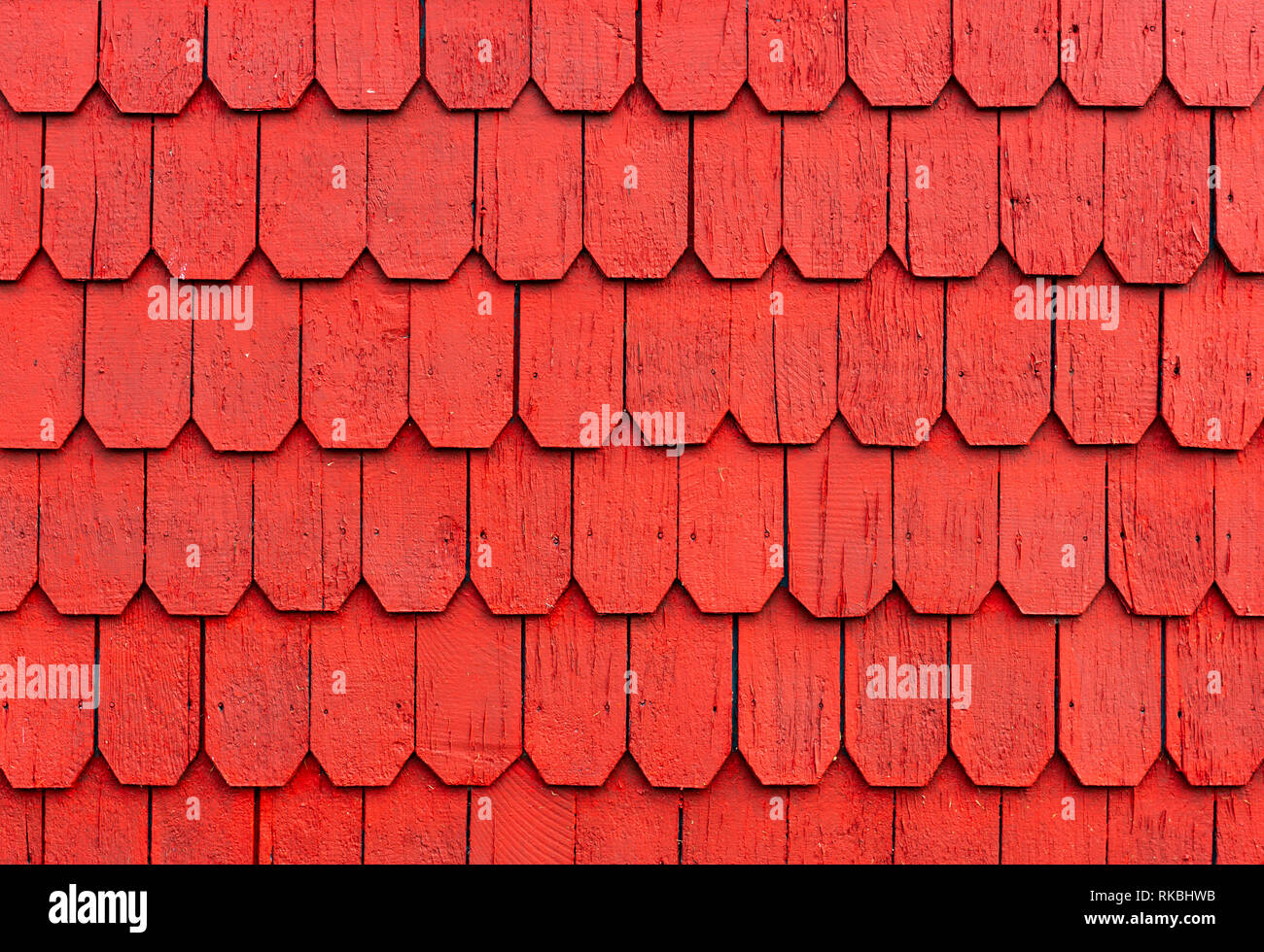 Red larch tree wood panel decorations on the outside wall of houses in the Lake District of Chile in Puerto Montt, Puerto Varas and Chiloe Island. Stock Photo