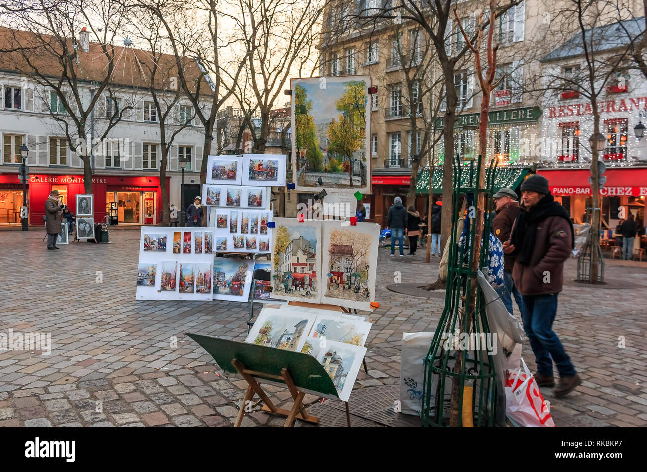 Artists awaiting customers amongst easels and artwork set up in Place du Tertre in Montmartre Paris, France Stock Photo