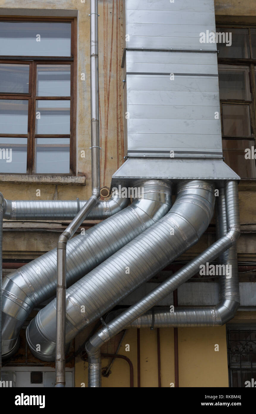 Ventilation and air conditioning system near to the window on the old house wall Stock Photo