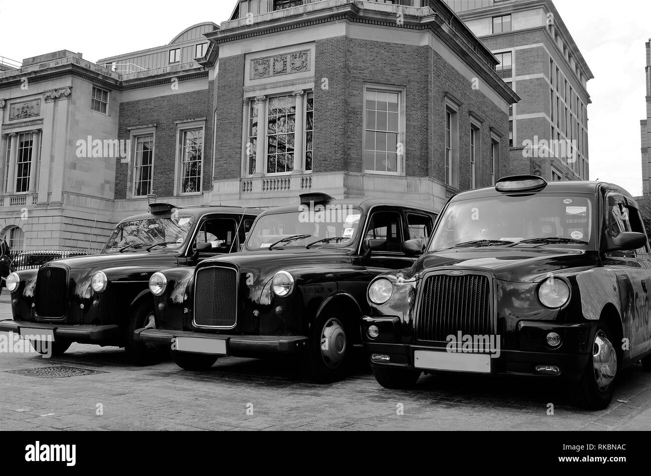 London vintage cabs waiting in the street. Black and white. United Kingdom Stock Photo