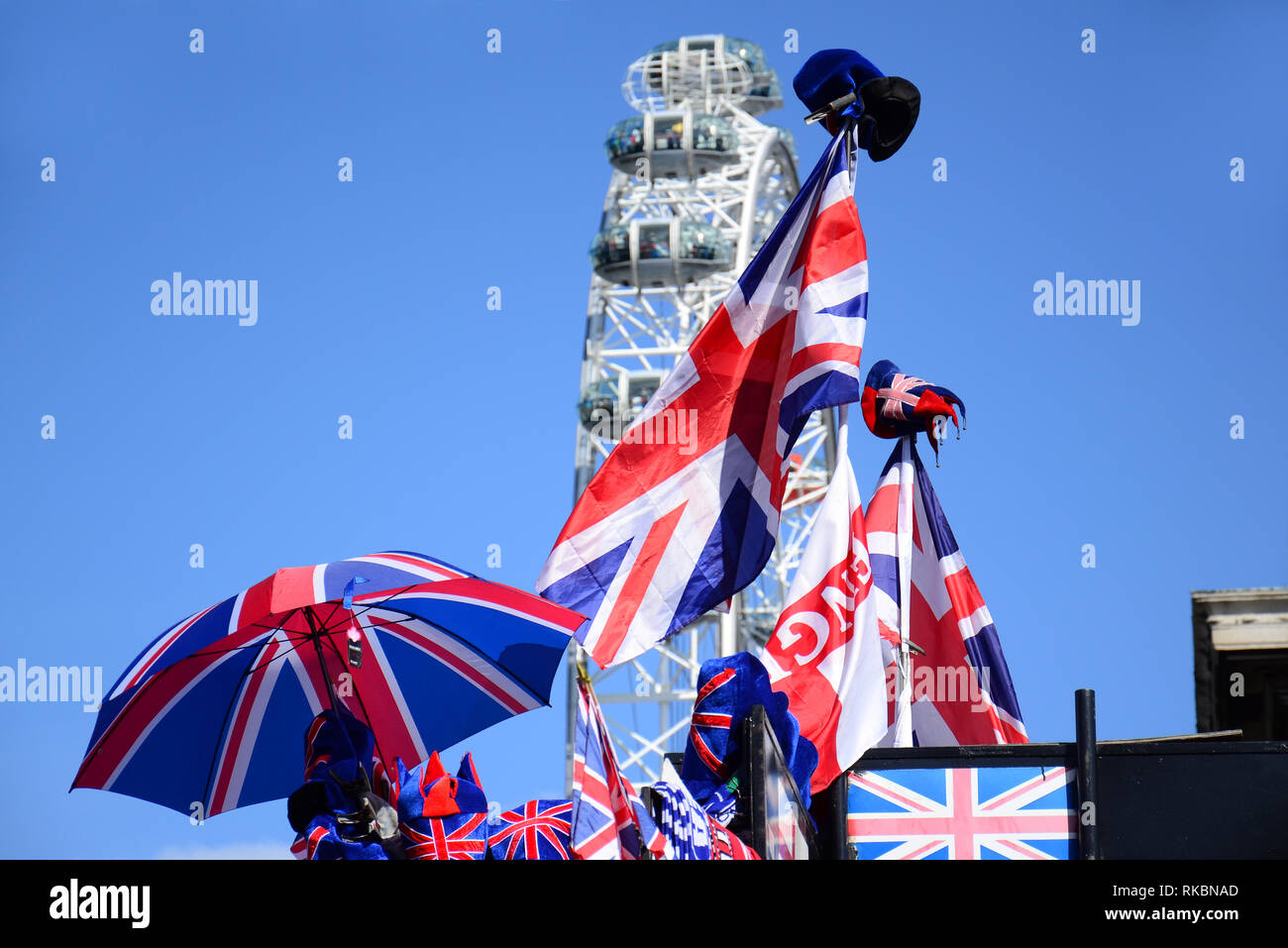 The english flag and souvenirs with the London Eye on background. United Kingdom. Stock Photo