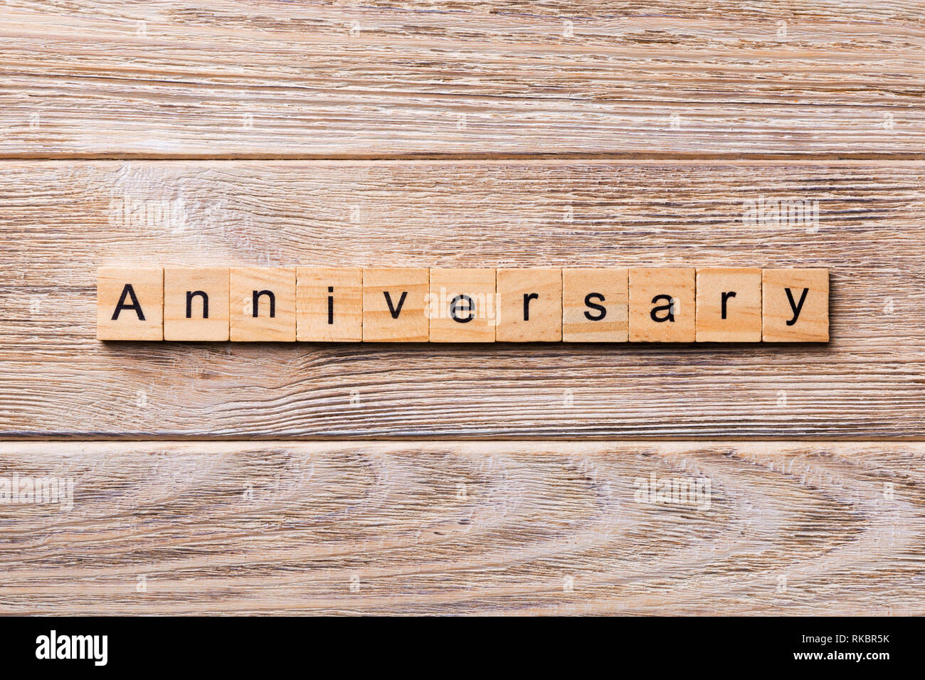 anniversary word written on wood block. anniversary text on wooden