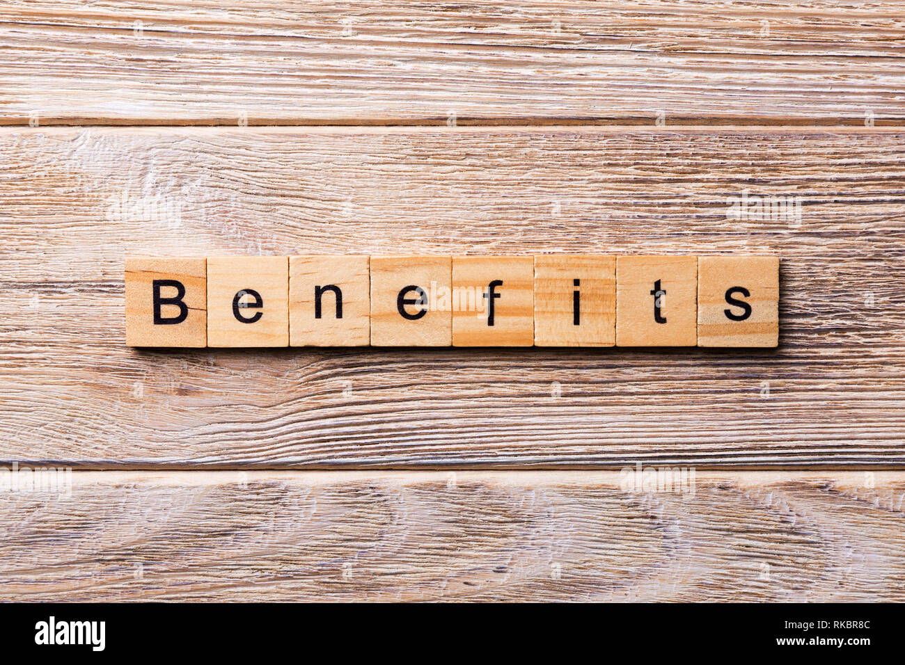BENEFITS word written on wood block. BENEFITS text on wooden table for