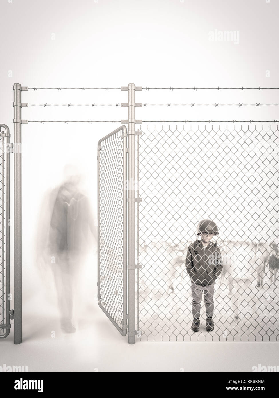 refugee child waits behind a border fence Stock Photo