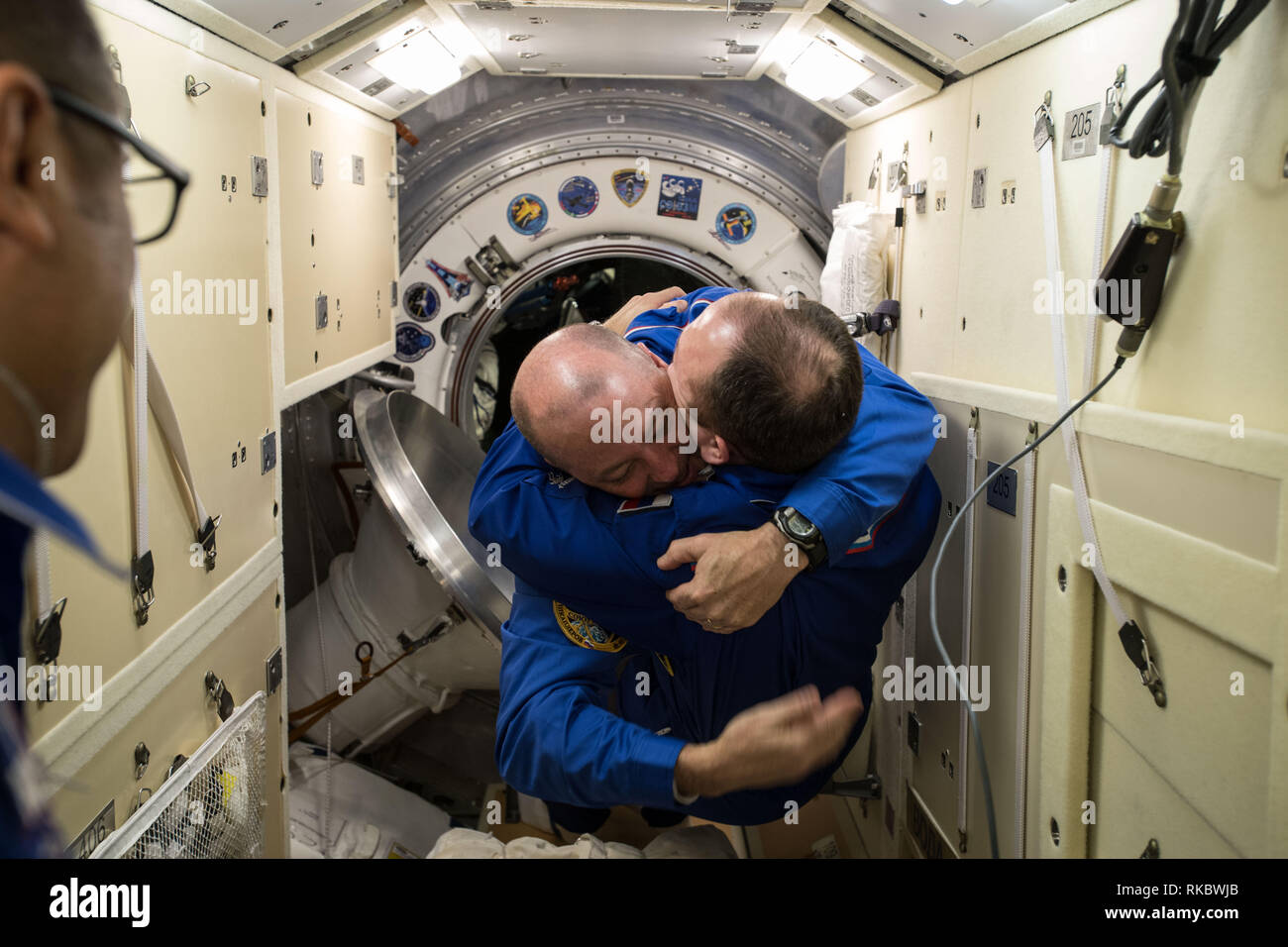 International Space Station Commander Alexander Misurkin welcomes newly arrived NASA astronaut Scott Tingle with a hug inside the Rassvet Mini-Research Module aboard the International Space Station December 19, 2017 in Earth Orbit. Tingle arrived moments before aboard the  Soyuz MS-07 spacecraft. Stock Photo