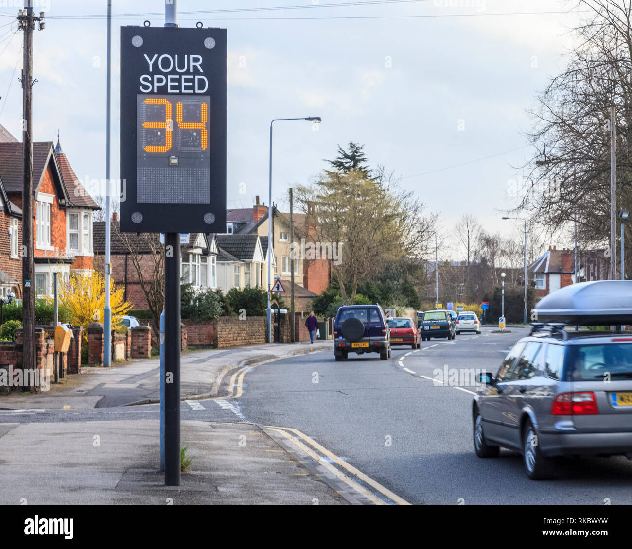 Driving too fast, slow down. A car exceeding the speed limit as it passes a traffic speed warning indicator in Nottinghamshire, England, UK Stock Photo