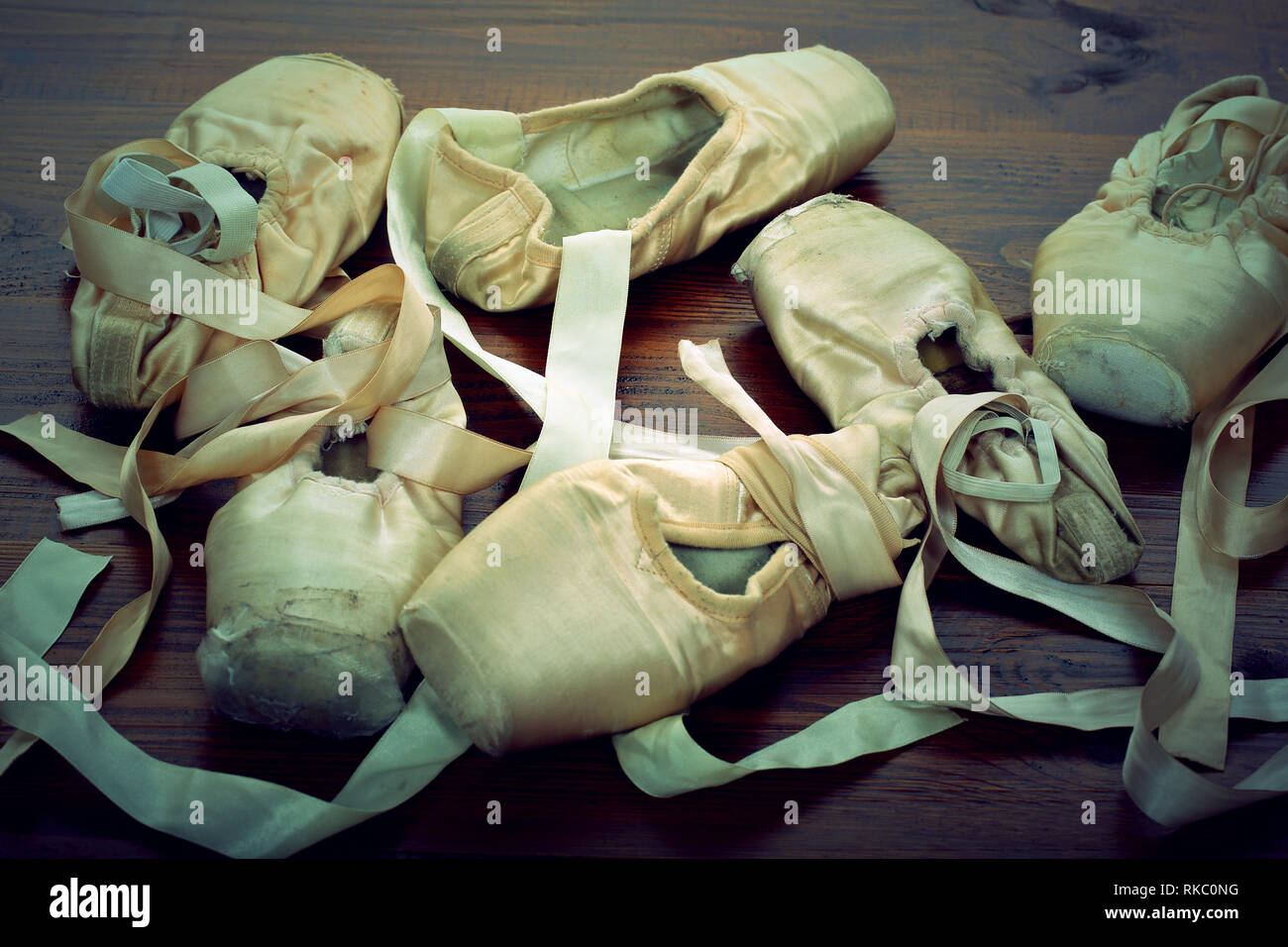 Pointes female ballet shoes on wooden background, close up vintage view Stock Photo