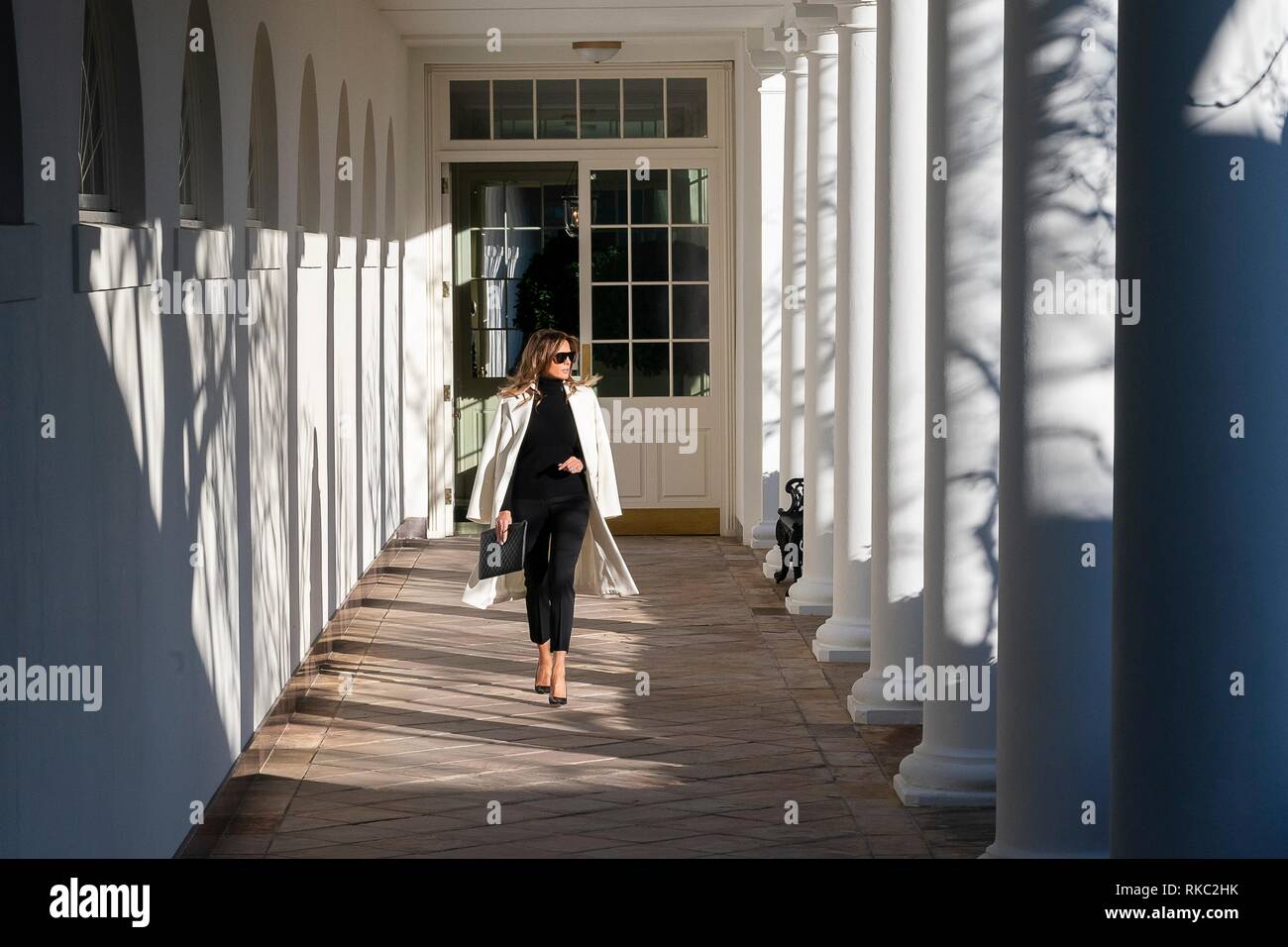 U.S. First Lady Melania Trump walks along the the Colonnade of the White House wearing black slacks and roll neck sweater with a white wool coat draped over her shoulders January 25, 2019 in Washington, D.C. Stock Photo