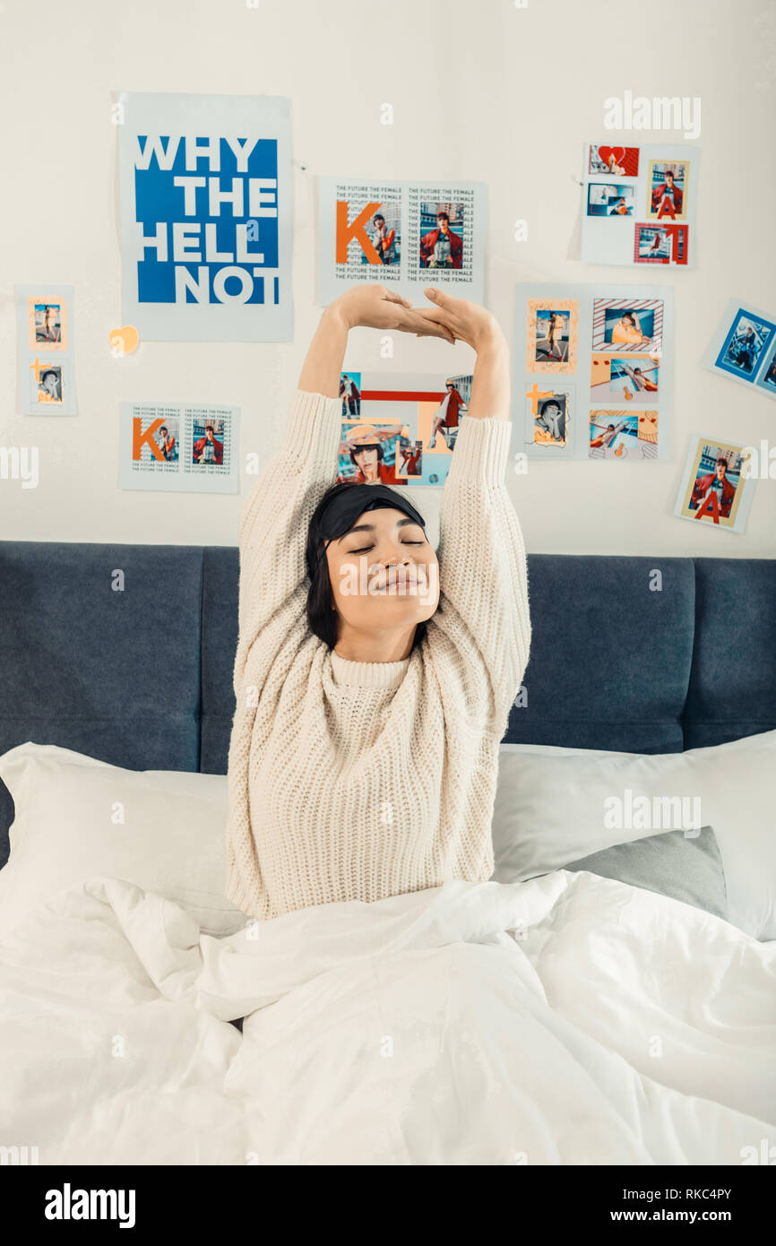 Young woman stretching while waking up in the morning Stock Photo