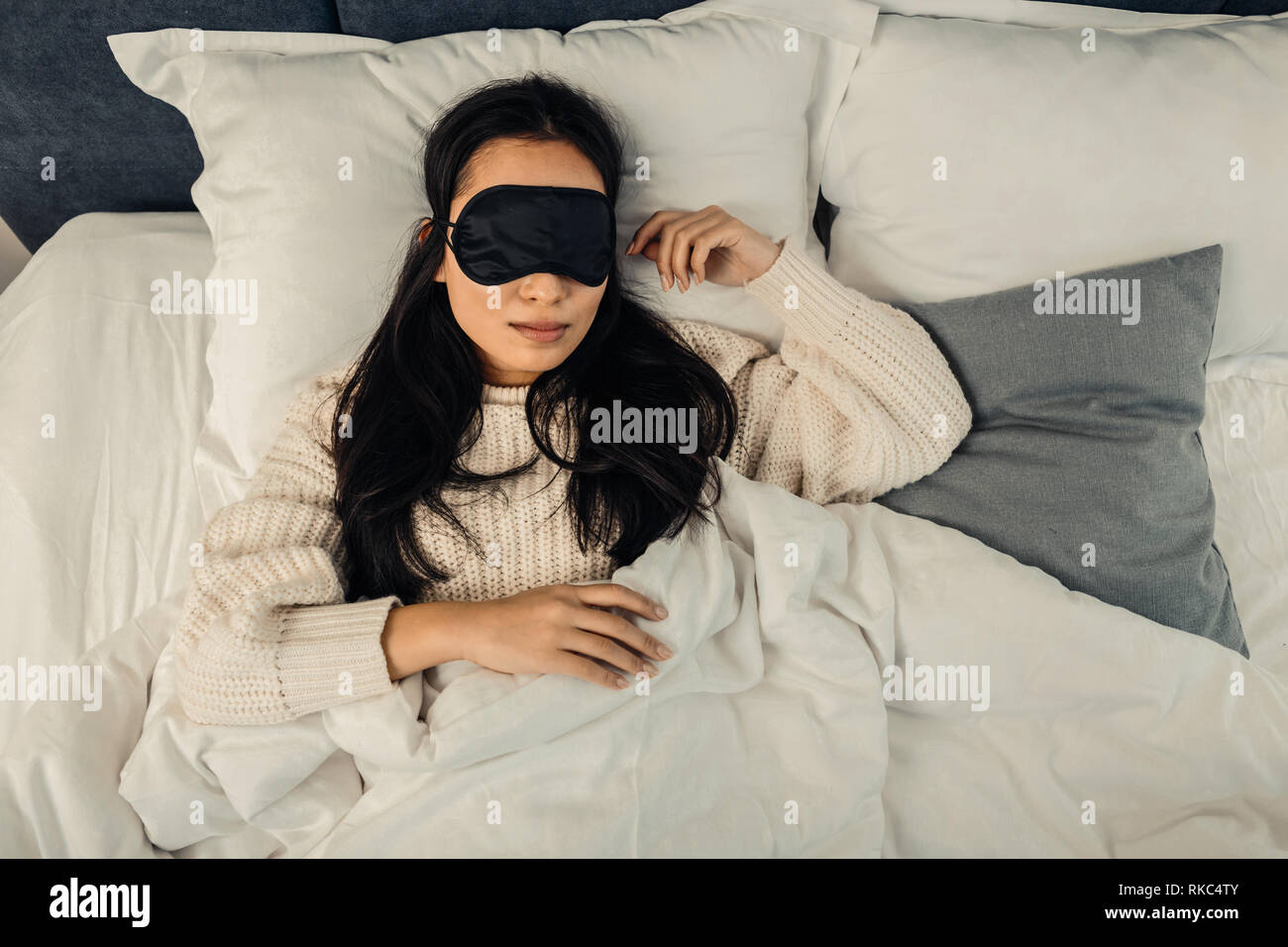 Dark-haired woman feeling relieved and relaxed while sleeping Stock Photo