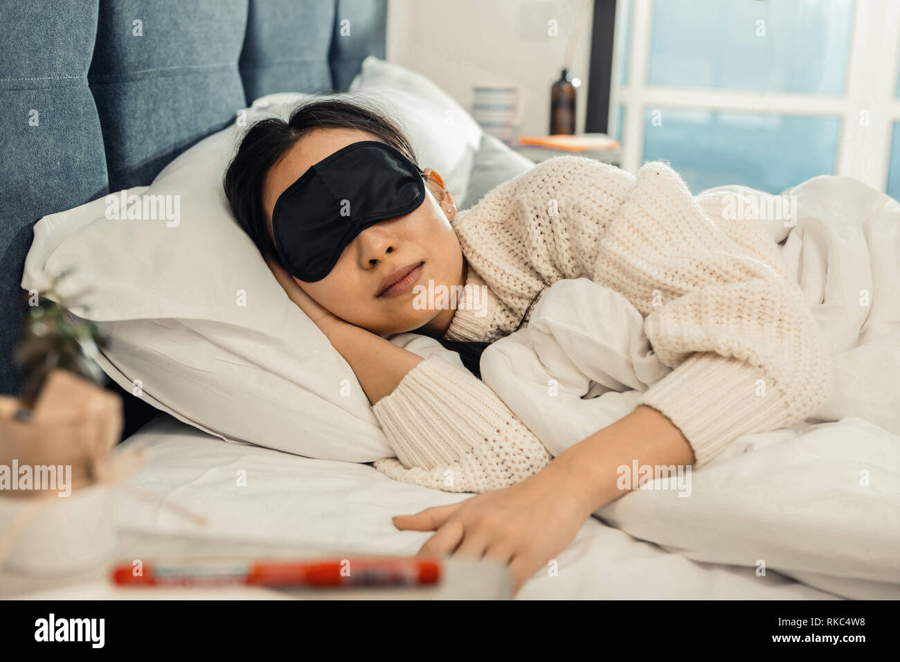 Young appealing woman sleeping at home after working day Stock Photo