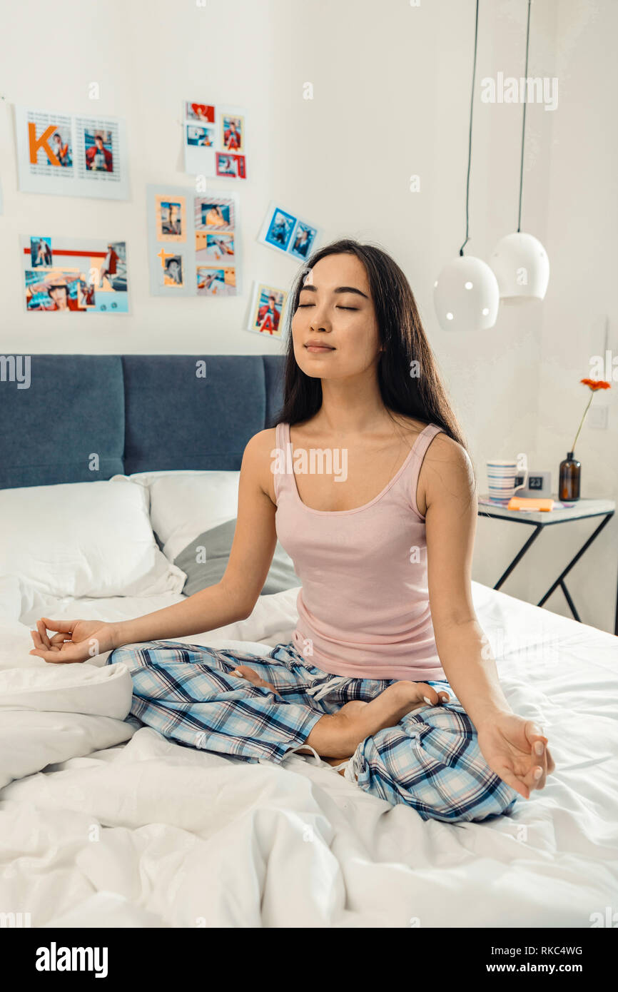 Slim appealing woman meditating in the morning Stock Photo