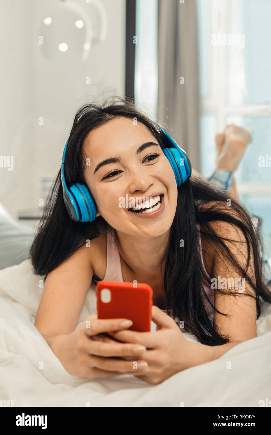 Woman feeling cheerful and relaxed while chilling at home Stock Photo