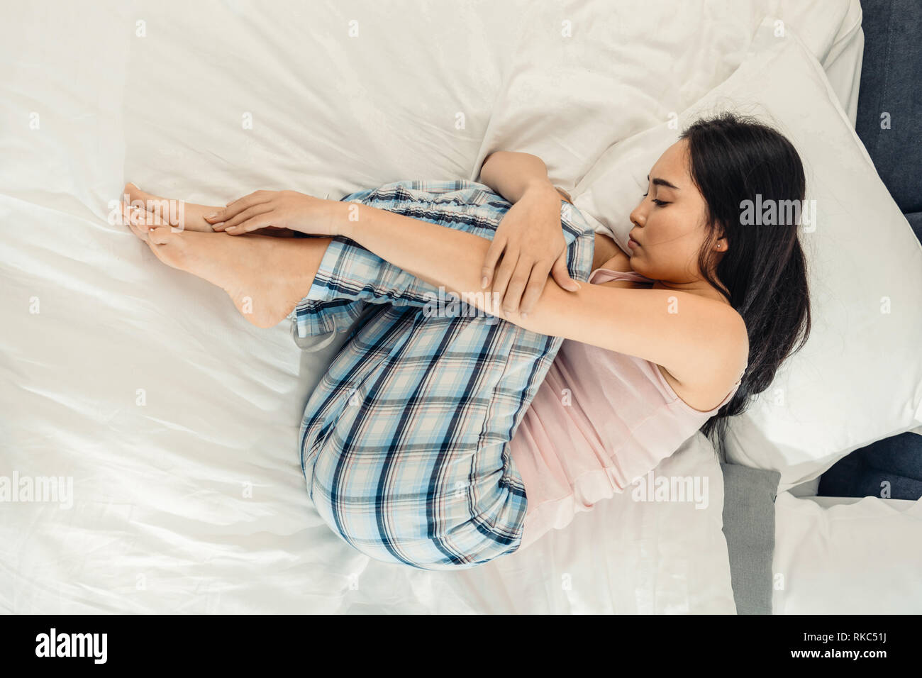 Asian woman feeling depressed and lonely lying in bed Stock Photo