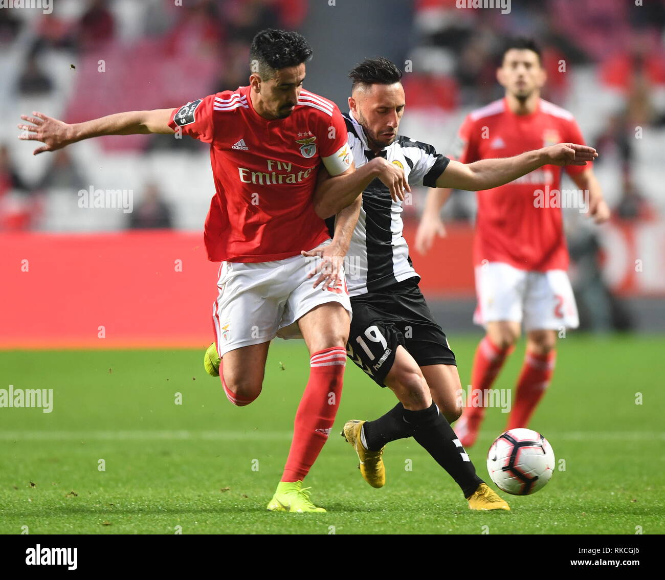 Lisbon, Portugal. 10th Feb, 2019. Andre Almeida (L) of Benfica vies with Joao Camacho of Nacional during the Portuguese League soccer match between SL Benfica and CD Nacional at Luz stadium in Lisbon, Portugal, on Feb. 10, 2019. Benfica won 10-0. Credit: Zhang Yadong/Xinhua/Alamy Live News Stock Photo