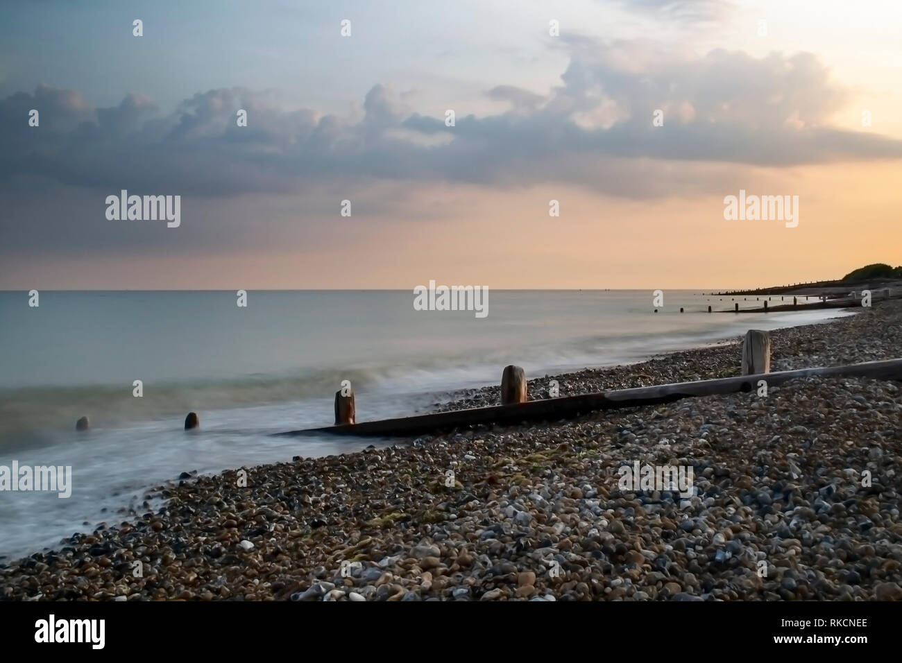 Worthing beach at the end of the day captured with a long exposure so the sea is smooth. Stock Photo